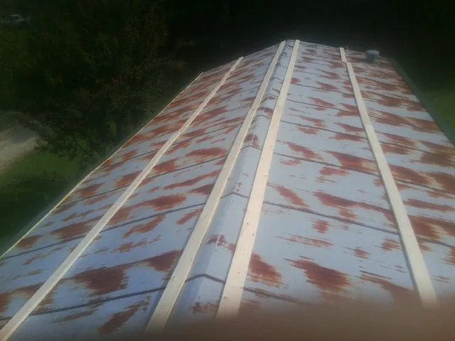 Rusted metal roof panels with new wood purlins before replacement — Storm Damage Roof Repair in Roachdale by Roofing Brothers